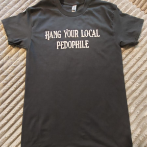 T-shirt laying flat for display says "hang your local pedophile"